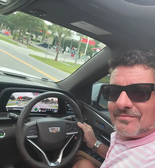 Red Star owner David Gilley in sunglasses at the wheel of the Cadillac Escalade